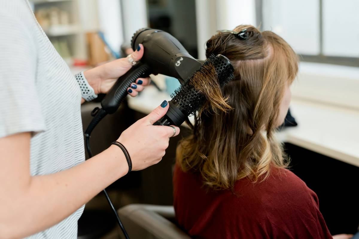 Hair Control achieved with a matte-finish claw clip holding thick, wavy hair in a low bun
